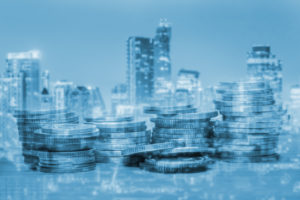 Double exposure of coins and city for business finance concept.